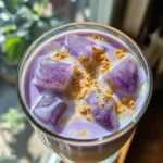 A taro latte is a creamy drink made from taro root. This drink has gained popularity in many cafes. It features a beautiful purple hue and a sweet, nutty flavor. You can enjoy it hot or iced, depending on your mood. The main ingredients are taro root, milk, and sweeteners. This treat is perfect for anyone who loves unique flavors. The flavor of a taro latte is smooth and slightly sweet. It combines the earthiness of taro with the creaminess of milk. You can choose any milk you like, such as almond or oat. Here are the key ingredients you need: - 1 cup taro root, peeled and diced - 2 cups water - 1 cup milk (choose between dairy or non-dairy options) - 2-3 tablespoons sugar or sweetener (adjust based on your sweetness preference) - 1/2 teaspoon vanilla extract - A pinch of salt - Ice cubes (optional, for serving an iced version) - Taro powder for garnish (optional, for added visual appeal) These ingredients create a delightful balance of flavors. The vanilla adds warmth, while the sugar enhances the sweetness. Taro is not just tasty; it is also good for you! It’s rich in fiber, which helps with digestion. Eating taro can boost your energy, too. It has vitamins and minerals that support your immune system. Plus, it is low in fat, making it a smart choice for snacks or drinks. Enjoying a taro latte gives you a delicious treat with health benefits. If you want to try making it yourself, check out the Full Recipe. To make a tasty taro latte, you need a few simple ingredients: - 1 cup taro root, peeled and diced - 2 cups water - 1 cup milk (dairy or non-dairy) - 2-3 tablespoons sugar or sweetener - 1/2 teaspoon vanilla extract - A pinch of salt - Ice cubes (optional) - Taro powder for garnish (optional) You can choose milk based on your taste or dietary needs. Here are some great options: - Whole milk adds creaminess. - Almond milk gives a nutty flavor. - Oat milk is very smooth. - Coconut milk brings a tropical twist. - Soy milk is a popular choice. Sweetness makes your taro latte delightful. You can use: - White sugar for a classic taste. - Brown sugar for a deeper flavor. - Honey for a natural sweet option. - Maple syrup for unique sweetness. - Stevia for a low-calorie choice. Feel free to adjust sweetness based on your liking. For the complete recipe, check out the Full Recipe. Start by peeling and dicing the taro root. Cut it into small pieces. This helps it cook faster. Place the diced taro in a pot. Add 2 cups of water to cover the taro completely. Bring the water to a boil over medium heat. Once it boils, lower the heat to simmer. Let it cook for 15-20 minutes. Check if the taro is tender by piercing it with a fork. If it goes in easily, it’s done! After cooking, drain the water from the taro. Move the soft taro to a blender. Add 1 cup of milk, 2-3 tablespoons of sugar, 1/2 teaspoon of vanilla extract, and a pinch of salt. Blend everything until it is smooth and creamy. If you want a warm latte, pour the mixture back into the pot. Heat it gently while stirring. For an iced version, fill a glass with ice and pour the blended mixture over it. To finish, sprinkle some taro powder on top for garnish. This adds a nice touch and flavor. Now, you can enjoy your tasty taro latte! For the full recipe, check the provided link. {{image_4}} To get the best texture for your taro latte, blend well. After cooking, make sure to blend the taro until smooth. If your mixture seems too thick, add a bit more milk. This will help create a creamy drink that feels great in your mouth. Remember, the smoother the blend, the better your drink! Finding the right sweetness is key. Start with 2 tablespoons of sugar. Taste the latte, and if you want it sweeter, add more sugar one teaspoon at a time. You can also use honey or a sugar substitute. Just remember to mix well after each addition to see how much you like it. You can enjoy your taro latte hot or iced. If you like it warm, heat the blended mixture gently on the stove. Stir it often to keep it creamy. For an iced version, pour the latte over ice cubes in a tall glass. This will make a refreshing drink, perfect for warm days. Each way gives a different vibe to your treat! For more details, check out the Full Recipe. You can turn your taro latte into a fun taro milk tea. Start with the same base of cooked taro and milk. After blending, steep some strong black tea. Combine the taro mixture with the tea for a creamy, sweet drink. This adds a nice caffeine boost. Just mix it well and serve it over ice for a refreshing treat. If you want a vegan version, simply swap the milk for a plant-based option. Almond, oat, or coconut milk work great. They add their own taste to the latte. Use a natural sweetener like agave syrup instead of regular sugar. This way, you keep it creamy and delicious without any dairy. You can also play with flavors to make your taro latte special. Adding matcha gives it a bright green color and earthy taste. Just mix in a teaspoon of matcha powder when blending. For a chocolate twist, add cocoa powder for a rich, sweet flavor. These fun additions make your drink unique and exciting. Try different combinations to find your favorite! For more details, check the Full Recipe. You can make a tasty taro latte at home easily. First, gather the ingredients. You need taro root, water, milk, sugar, vanilla, and salt. Follow the steps in the Full Recipe above. Start by boiling the taro until it’s soft. Then, blend it with milk and other ingredients. You can serve it warm or cold. Enjoy your homemade treat! You can buy taro powder in many places. Look in local Asian markets or grocery stores. Online stores also sell it, making it easy to find. Check for brands that have good reviews. Taro powder adds great flavor and color to your drinks! Yes, you can use frozen taro. Frozen taro is a good option if fresh taro is hard to find. Just thaw it before cooking. Follow the same cooking steps as fresh taro. You will still get the creamy taste and lovely color for your latte! A Taro Latte blends unique flavors and health perks. We explored its ingredients, cooking steps, and how to customize your drink perfectly. You can create a tasty latte hot or iced, vegan or with milk. Remember, experimenting with sweetness makes a big difference in flavor. Taro lattes not only taste great but also provide health benefits. Now, it's time to enjoy your own homemade Taro Latte, a delicious drink you can share with friends.