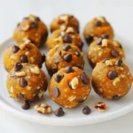 To make Pumpkin Pie Energy Bites, you need these simple ingredients: - 1 cup rolled oats - 1/2 cup pumpkin puree - 1/4 cup almond butter (or peanut butter) - 1/4 cup honey or maple syrup - 1 teaspoon pumpkin pie spice - 1/2 teaspoon pure vanilla extract - 1/4 cup mini chocolate chips (optional) - 1/4 cup chopped nuts (optional) - A pinch of salt These ingredients blend together to create a tasty treat. The oats provide fiber, while pumpkin puree gives moisture and flavor. Almond butter or peanut butter adds healthy fats and protein. Honey or maple syrup sweetens the bites. The pumpkin pie spice brings the warm flavors of fall, making each bite feel cozy. If you want something sweet, add mini chocolate chips. For crunch, toss in chopped nuts like walnuts or pecans. The pinch of salt enhances all the flavors. Gather these ingredients, and you are ready to create a snack that is both fun and healthy! First, grab a large mixing bowl. In it, combine 1 cup of rolled oats with 1/2 cup of pumpkin puree. This mix forms a hearty base. Next, add 1/4 cup of almond butter. If you prefer, you can use peanut butter instead. Then, pour in 1/4 cup of honey or maple syrup for sweetness. Use a spatula or wooden spoon to mix everything until it feels smooth and well combined. Now it’s time to add flavor! Sprinkle in 1 teaspoon of pumpkin pie spice and 1/2 teaspoon of pure vanilla extract. These spices will give the bites their warm, cozy taste. Don’t forget to add a pinch of salt; it really enhances the flavor. If you want a little extra fun, you can mix in optional ingredients like mini chocolate chips or chopped nuts. With clean hands, scoop out about 1 tablespoon of the mixture. Roll it into a ball shape. Place each ball onto a parchment-lined baking sheet. Make sure to leave space between the balls. This helps them keep their shape while chilling. Once all the bites are formed, it’s time to chill. Pop the baking sheet in the fridge for at least 30 minutes. This step helps firm up the energy bites. After chilling, they are ready to eat or can be stored in an airtight container. To make your Pumpkin Pie Energy Bites stick well, mix the ingredients thoroughly. This helps bind everything together. If the mixture feels too dry, add a bit more pumpkin puree or almond butter. These tweaks ensure that every bite holds its shape and taste. Feel free to get creative with your bites! If you prefer a different nut, swap almond butter for peanut butter or sunflower seed butter. You can also change the nuts you add in. Try walnuts, pecans, or even cashews. Each nut brings its own flavor and texture, making the bites unique. You can serve these bites in fun ways. Arrange them on a colorful plate for a festive look. For a special touch, sprinkle extra pumpkin pie spice on top. These bites also pair well with a side of yogurt or fresh fruit, adding to the fun and flavor. Enjoy exploring different ways to serve and share! {{image_4}} You can easily swap almond butter for peanut butter. Both give great flavor. If you want a nut-free option, try sunflower seed butter. For sweeteners, honey is delicious, but maple syrup works too. You can even use agave syrup if you prefer. Each choice adds its own twist to the bites. To add more taste, mix in shredded coconut or chopped dried fruit. Dried cranberries or cherries add a nice chewiness. You can also try adding a tablespoon of cocoa powder for a chocolatey flavor. These changes keep the bites fun and exciting every time you make them. For a gluten-free version, use certified gluten-free oats. Be careful with cross-contamination. If you need these bites to be nut-free, swap nut butter with sunflower seed butter. Always read labels to ensure no hidden allergens. Making these changes lets everyone enjoy them without worry! To keep your pumpkin pie energy bites fresh, use an airtight container. This type of container helps keep air out. You can store them in the fridge or at room temperature for a short time. If you store them in the fridge, they will stay tastier and last longer. These energy bites stay fresh for about one week in the fridge. If you leave them out, they might only last a few days. Always check for any changes in smell or texture. If they look or smell off, it’s best to toss them. Freezing is a great option if you want to save some bites for later. To freeze, place the energy bites in a single layer on a baking sheet. Freeze them for about an hour. After that, transfer them to an airtight container or a freezer bag. They can last up to three months in the freezer. When ready to eat, just let them thaw in the fridge or at room temperature. Enjoy them any time! These bites stay fresh for about a week in the fridge. Store them in an airtight container. This keeps them tasty and prevents them from drying out. If you want to keep them longer, you can freeze them for up to three months. Just let them thaw in the fridge before you eat them. Yes, you can use fresh pumpkin! First, cook and mash the pumpkin. Steam or roast it until it's soft. This will help make it smooth. Then, mash it well to get a similar texture to the puree. Use about the same amount as the recipe calls for. Yes, these bites are a healthy snack! They are packed with nutrients. Pumpkin is high in fiber and vitamins. Oats provide whole grains for energy. Almond butter gives you healthy fats and protein. If you add nuts, you get even more nutrients. They are a great energy boost without added sugar. Absolutely! To make these bites vegan, swap honey for maple syrup. Almond butter is usually vegan, but check the label. You can also use any nut butter or seed butter. This keeps the bites tasty and suitable for a vegan diet. Enjoy making these yummy treats! You can create tasty pumpkin pie energy bites easily with these steps. We covered the key ingredients, mixing, and forming the bites. I shared tips on customizing flavors and storing them well. These bites are not just fun to make; they are also healthy. Enjoy them as a snack or a treat. Try different swaps to suit your tastes. Get started making these energy bites today!